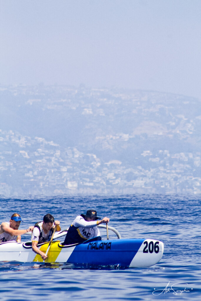 Men paddling outrigger canoe