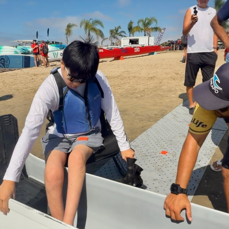 Adaptive Paddler getting in canoe