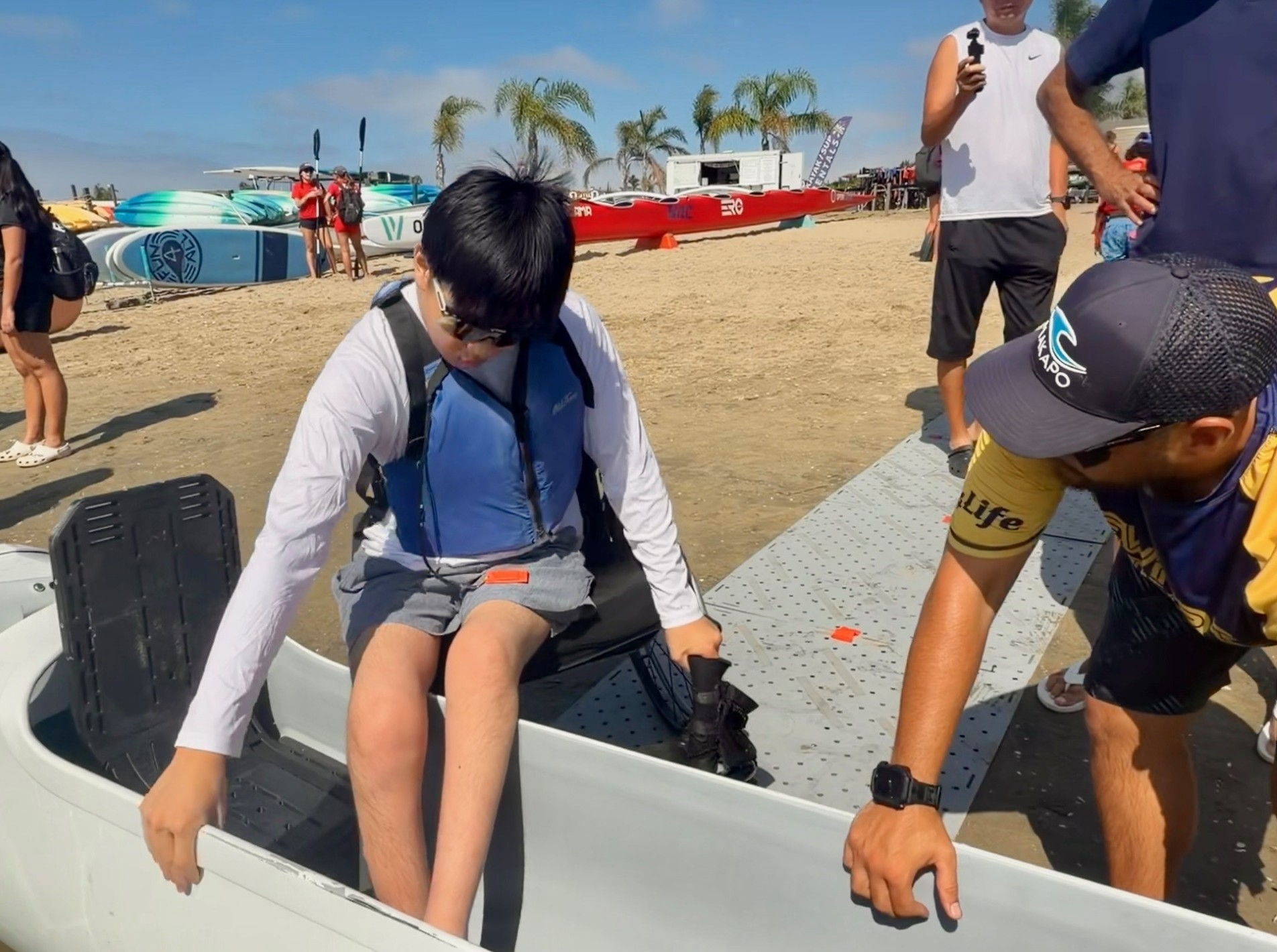 Adaptive Paddler getting in canoe